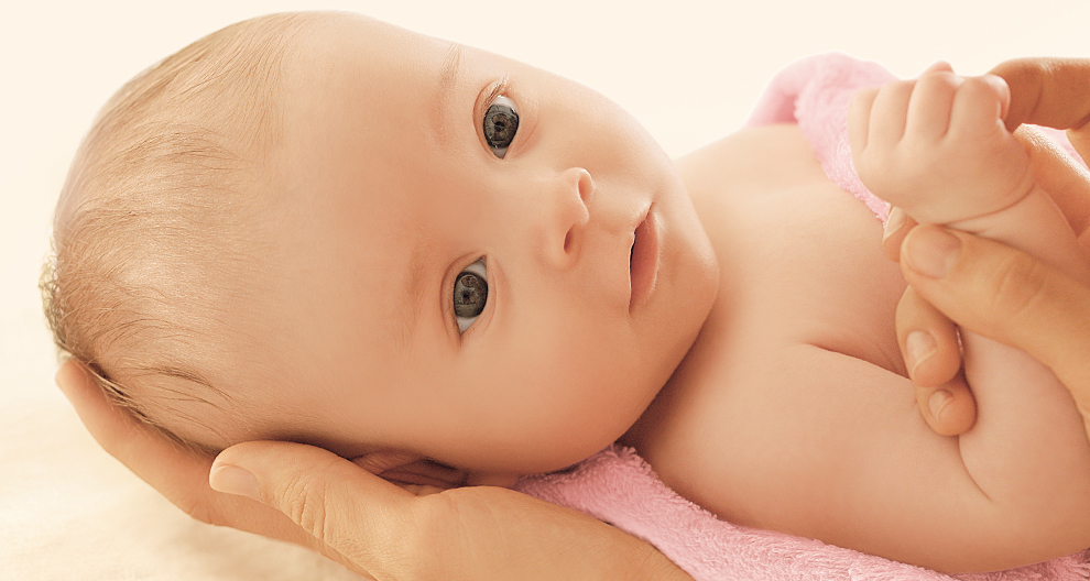 Baby, hands, pink towel.
